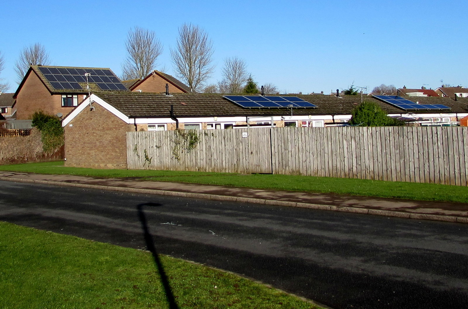 Home Batteries Change the Maths of Rooftop Solar Solar panels on the roof of a house under a clear blue sky.